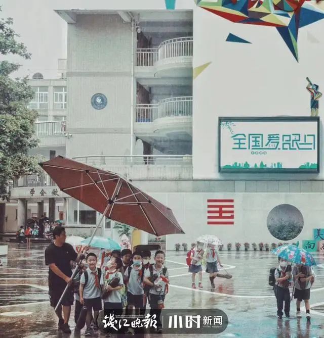 老师用超大雨伞护送学生，家长朋友圈配文：小朋友雨天的专属快乐