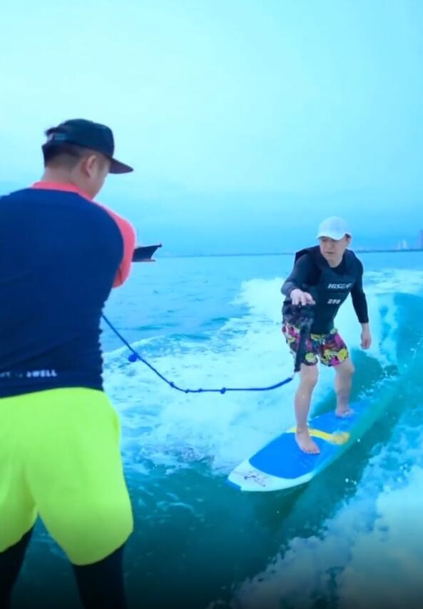 黄渤海边学冲浪心情好 赤脚与粉丝合影自然接地气