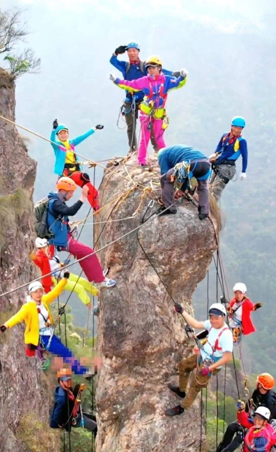 胆战心惊！10余男女攀上细长垂直岩壁集体晃动拍视频
